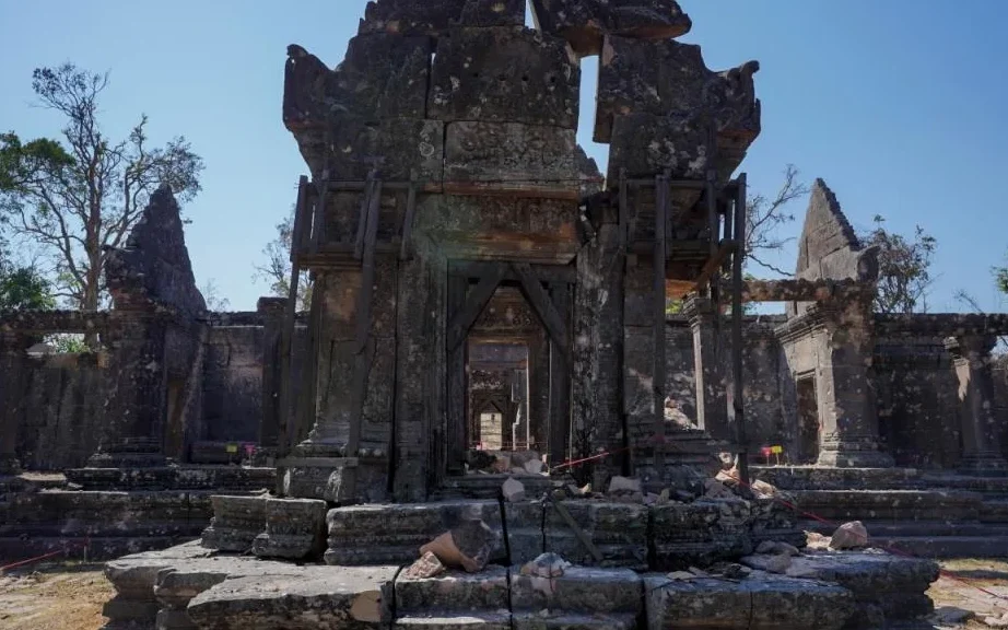 Ancient stone temple ruins under a clear blue sky.