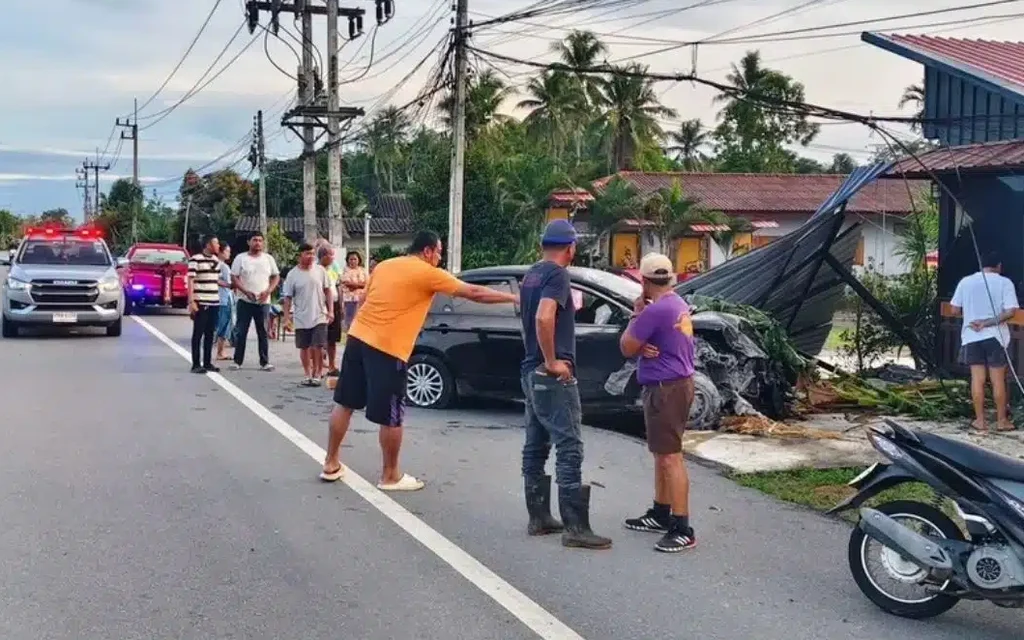 People and emergency vehicles at a roadside car crash scene