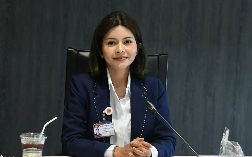 A woman in a suit sitting at a table.