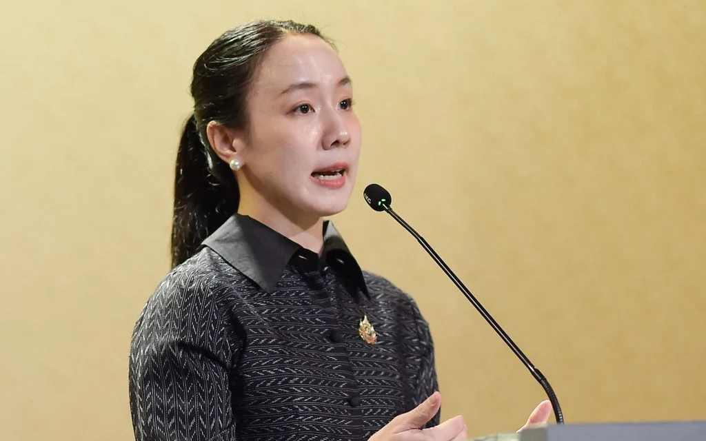 Woman speaking at a podium with a microphone