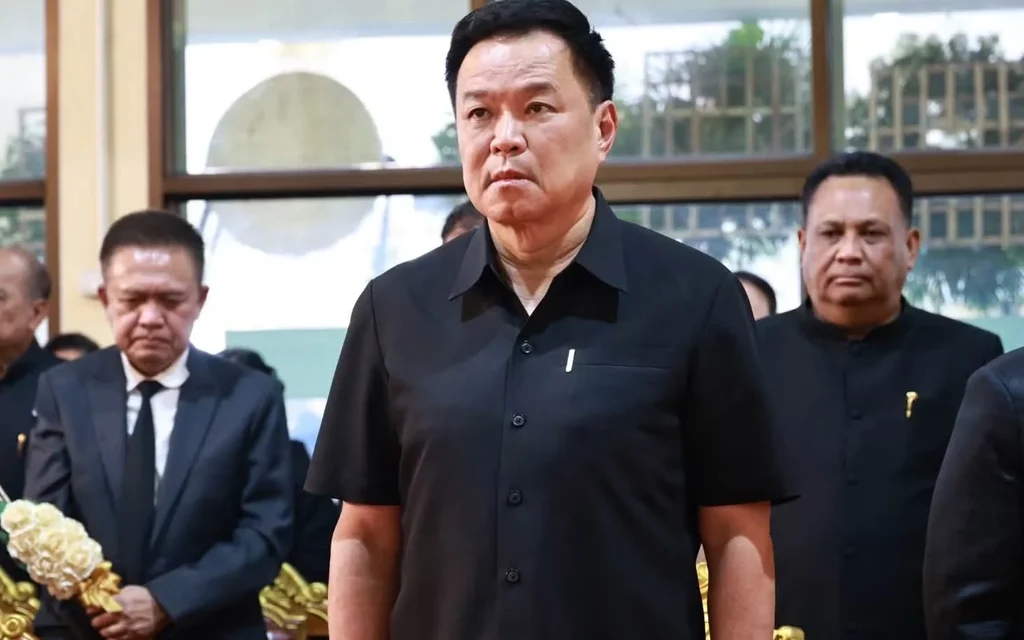 Thai officials attend a funeral ceremony in a hall.