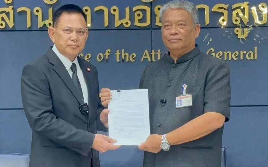 Two officials pose holding a document at the Attorney General’s office.