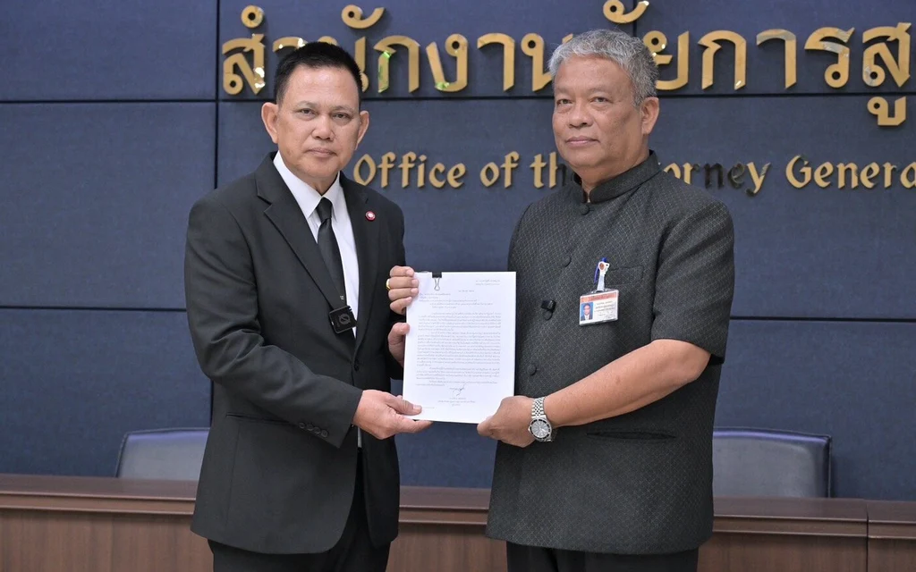 Two men pose holding a document at the Office of the Attorney General.