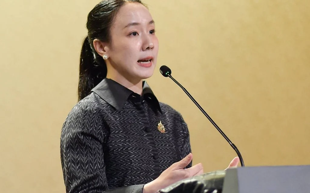 A woman speaks at a podium with a microphone.